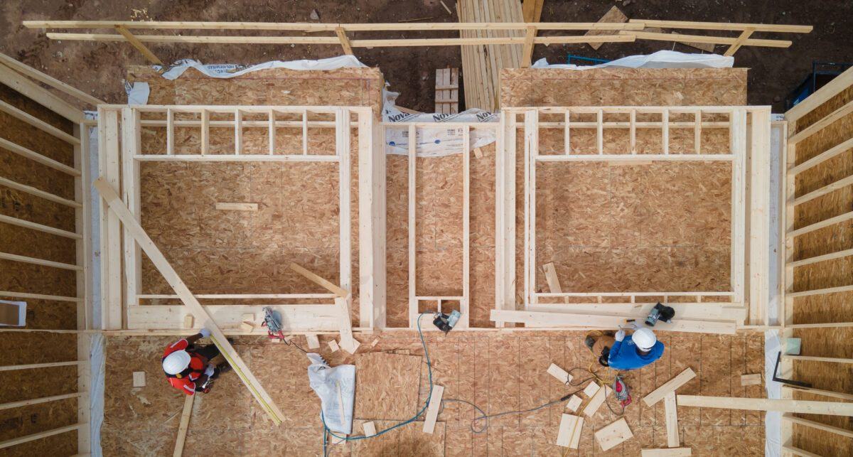 Aerial view of carpenters framing the walls of a new house